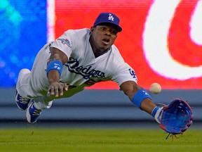 Los Angeles outfielder Yasiel Puig can't catch a ball hit by David Freese of the Cardinals during the fifth inning of Game 3 of the National League championship series. (AP Photo/Mark J. Terrill)