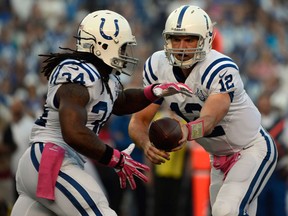 Indy quarterback Andrew Luck, right, hands off the ball to Trent Richardson against San Diego Monday at Qualcomm Stadium in San Diego. (Photo by Donald Miralle/Getty Images)