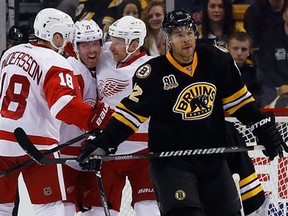 Boston's Jarome Iginla, right, skates away as Detroi's Joakim Andersson, left, and Daniel Alfredsson, right, celebrate a goal by Daniel Cleary Monday. (AP Photo/Elise Amendola)