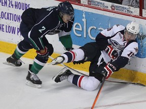 Windsor's Kerby Rychel, right, is checked by Plymouth's Alex Peters at the WFCU Centr. (DAN JANISSE/The Windsor Star)