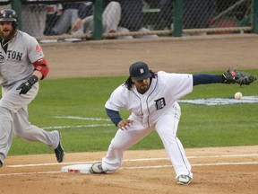 Boston's Jonny Gomes, left, is safe at first as Detroit's Prince Fielder takes the throw from Jhonny Peralta in the fifth inning during Game 3 of the American League championship series Tuesday. (AP Photo/Charlie Riedel)