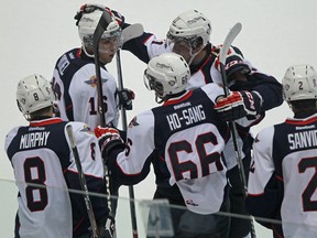 Trevor Murphy, from left, Kerby Rychel, Josh Ho-Sang, Nikita Yazkov, and Patrick Sanvido, celebrate Ho-Sang's goal against the Niagara IceDogs. (DAX MELMER/The Windsor Star)