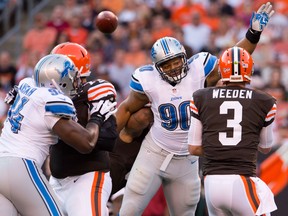 Detroit's Ndamukong Suh, centre, tries to deflect a pass by Cleveland quarterback Brandon Weeden during a pre-season game at FirstEnergy Stadium.(Photo by Jason Miller/Getty Images)