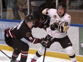 LaSalle's Brendan McCann, right, is checked by Sarnia's Ryan Vendramin Wednesday at the Vollmer Centre. (JASON KRYK/The Windsor Star)