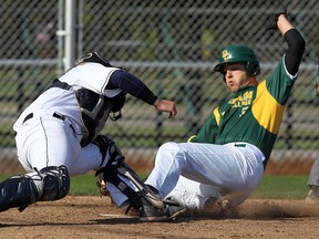 Humber catcher Colin Gingerich, left, is just late with the tag as Durham's Michael Cyr slides safely into home at Lacasse Park Friday. (TYLER BROWNBRIDGE/The Windsor Star)