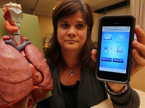 Madonna Ferrone, co-ordinator primary care, Lung Health Program, displays an app developed to assist patients with asthma, October 31, 2013. (NICK BRANCACCIO/The Windsor Star)