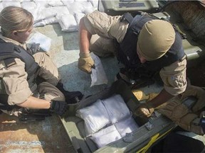Boarding Party members of Her Majesty's Canadian Ship Toronto pack up seized narcotics after searching a suspected smuggling vessel in the Arabian Sea region on October 5, 2013. (Dan Bard, Formation Imaging Services, Halifax, Nova Scotia / DND-MDN Canada, Canada.com)