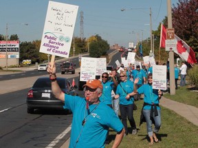 Frustrated customs officers protested Thursday, Oct. 10, 2013, outside the Canada Border Services Agency offices in Windsor, demanding a 'fair contract' that includes job protection. The local protest of about 70 CBSA workers was part of a national day of action to highlight that customs officers have been without a contract since June 2011. In particular, CBSA workers want the Treasury Board, which negotiates on behalf of the government, to guarantee that customs officers cannot be terminated for failing firearms tests in the future. (JASON KRYK/The Windsor Star)