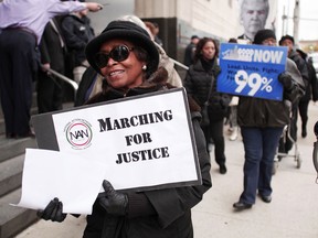 Protestors rally in front of the U.S. Courthouse in Detroit where Detroit's bankruptcy eligibility trial is taking place October 28, 2013 in Detroit, Michigan. Michigan Gov. Rick Snyder is expected to testify today at the trial. A federal judge will decide if the City of Detroit is eligible to be in bankruptcy court. (Photo by Bill Pugliano/Getty Images)