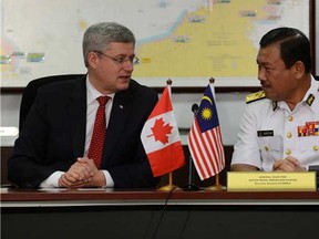 Prime Minister Stephen Harper is given a briefing on security by Admiral Datuk Mohd Amdan Kurish as he takes part in a tour of the Malaysian Maritime Enforcement Authority Air Station in Kuala Lumpur on Saturday, October 5, 2013. Harper will travel to the APEC Leaders' Meeting in Bali, Indonesia following his state visit to Malaysia. (THE CANADIAN PRESS/Sean Kilpatrick , Postmedia News)