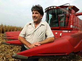 Farmer Leonard Mailloux is shown next to a corn combine harvester in a field near Amherstburg on Thursday, October 3, 2013.          (TYLER BROWNBRIDGE/The Windsor Star)