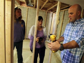 Home improvement expert Bryan Baeumler gives Cynthia Jamieson, centre, and her cousin Jodi Main a tour of Jamieson's home to discuss plans for the rebuilding in Windsor on Wednesday, October 9, 2013.              (TYLER BROWNBRIDGE/The Windsor Star)