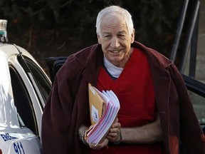 In this Jan. 10, 2013, file photo, former Penn State assistant football coach Jerry Sandusky arrives at the Centre County Courthouse for a post-sentencing hearing in Bellefonte, Pa. Penn State said Monday, Oct. 28, 2013 that it is paying $59.7 million to 26 young men over claims of child sexual abuse at the hands of Sandusky. The university said it had concluded negotiations that have lasted about a year. (AP Photo/Gene J. Puskar, File)