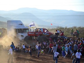 People run as an out-of-control monster truck plows through a crowd of spectators at a Mexican air show in the city of Chihuahua, Mexico, Saturday Oct. 5, 2013. According to authorities, at least 8 people were killed and 80 were injured. (AP Photo/El Diario de Chihuahua)