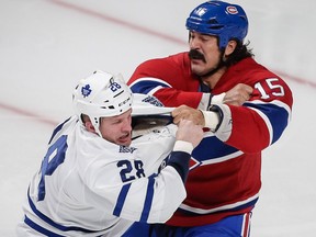 Montreal Canadiens right wing George Parros, right, fights with Toronto Maple Leafs right wing Colton Orr, left, during the third period of the NHL hockey season opening match between the Montreal Canadiens and the Toronto Maple Leafs in Montreal on Tuesday, October 1, 2013. Parros was taken out of the game in a medical stretcher. (Dario Ayala / THE GAZETTE)