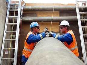 Enbridge workers perform do maintenance on the Enbridge 9b oil pipeline on Friday, September 20, 2013. Enbridge wants to reverse the flow of oil in Line 9 to service refineries in Ontario and Quebec, and will argue for that reversal in October. (Pierre Obendrauf, The Gazette)