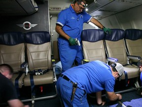 In this Sept. 23, 2013 photo, Southwest Airlines aircraft technicians install newer, skinnier seats on a 737 at the carrier's headquarters in Dallas. Southwest says passengers will have the same amount of legroom even though the new seats allow for another row onboard. (AP Photo/John Mone)