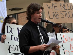 Rob Crawford, president of University of Windsor student alliance, speaks to a crowd of about 150 during a rally near the Chrysler Tower on Tuesday, Oct. 1, 2013.  (NICK BRANCACCIO/The Windsor Star)