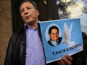 Ramiro Escoto holds a photo of his son, Takis Escoto, outside Superior Court Oct. 31, 2013, following the coroner's inquest into the death of his son, Takis Escoto. (NICK BRANCACCIO/The Windsor Star)