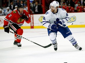 Toronto's Phil Kessel, right, is checked by Chicago's Duncan Keith in Chicago Saturday. (AP Photo/Andrew A. Nelles)