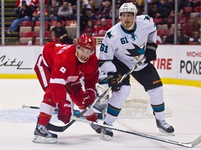 Detroit's Justin Abdelkader, left, checks San Jose's Tyler Kennedy during the first period Monday in Detroit. (AP Photo/Tony Ding)