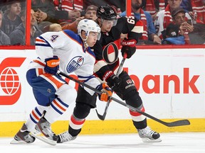 Ex-Spit Taylor Hall, left, is checked by Ottawa's Erik Karlsson during an NHL game at the Canadian Tire Centre in Ottawa. (Photo by Jana Chytilova/Freestyle Photography/Getty Images)