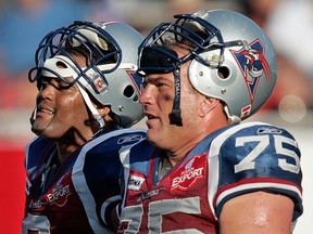 Essex native Ed Philion, right, and Anwar Stewart of the Alouettes take a break against the Saskatchewan Roughriders in 2006. (THE GAZETTE/John Mahoney)