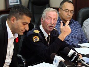 Windsor Mayor Eddie Francis, left, Windsor Fire Service Chief Bruce Montone and City treasurer Onorio Colucci, discuss an arbitration ruling between City of Windsor and Windsor Professional Firefighters Assocition Friday October 25, 2013. (NICK BRANCACCIO/The Windsor Star)