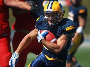 Lancers running back, Mitch Dender carries the ball against Carleton at Alumni Field. (DAX MELMER/The Windsor Star)