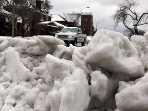 Mounds of snow are piled on Giles Boulevard East following a snowstorm on February 27, 2013. (NICK BRANCACCIO/The Windsor Star)
