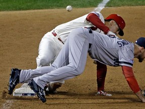 St. Louis' Allen Craig, left, gets tangled up with Boston's Will Middlebrooks during the ninth inning of Game 3 of the World Series in St. Louis. Middlebrooks was called for obstruction on the play and Craig went in to score the game-winning run. (AP Photo/David J. Phillip)