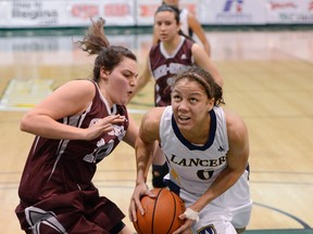 Lancers guard Korissa Williams, right, drives to the hoop against the Ottawa Gee-Gees at the CIS women's basketball championships at the University of Regina. (TROY FLEECE/Regina Leader-Post)