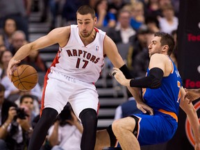 Toronto's Jonas Valanciunas, left, is guarded by New York's Andrea Bargnani in Toronto. (THE CANADIAN PRESS/Nathan Denette)