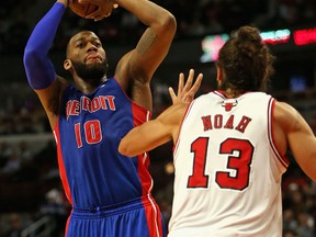 Detroit's Greg Monroe, left, shoots over Chicago's Joakim Noah at the United Center. (Photo by Jonathan Daniel/Getty Images)