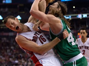 Boston's Kelly Olynyk, right, fouls Toronto's Steve Novak Wednesday in Toronto. (THE CANADIAN PRESS/Frank Gunn)