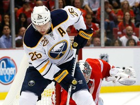 Buffalo's Thomas Vanek, left, tries to deflect the puck past Detroit goalie Jimmy Howard Wednesday. (AP Photo/Paul Sancya)