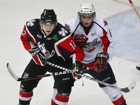 Ex-Spit Craig Duininck, right, checks LaSalle's Myles Doan of the IceDogs in 2010. (NICK BRANCACCIO/The Windsor Star)