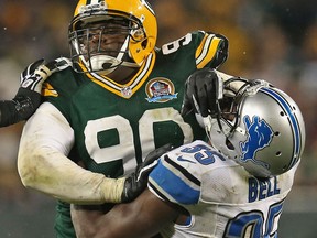 Green Bay's B.J. Raji, left, is blocked by Detroit's Joique Bell at Lambeau Field. (Photo by Jonathan Daniel/Getty Images)