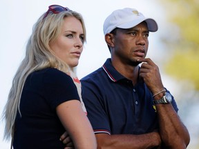 Tiger Woods, right, watches from the 17th hole with his girlfriend Lindsey Vonn during the four-ball matches at the Presidents Cup at Muirfield Village Golf Club in Dublin, Ohio. (AP Photo/Darron Cummings)
