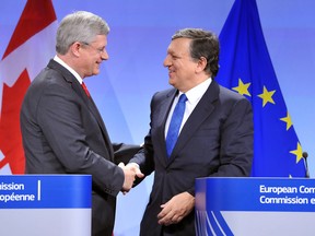 European Commission President Jose Manuel Barroso (R) shakes hand with Canadian Prime Minister Stephen Harper  to finalize a free trade accord more than four years in the making. GEORGES GOBET /AFP/Getty Images