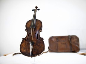 A picture dated September 16, 2013 shows the violin played by bandmaster Wallace Hartley during the final moments before the sinking of the Titanic with a leather carrying case initialed W H H at a conservation studio in Lurgan, Northern Ireland. (AFP PHOTO/ PETER MUHLY)