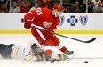 Detroit's Cory Emmerton, right, is tripped by Buffalo's Thomas Vanek at Joe Louis Arena. (Photo by Gregory Shamus/Getty Images)