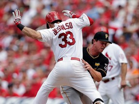 St. Louis' Daniel Descalso, left, is tagged out along the first baseline by Pittsburgh relief pitcher Tony Watson in the seventh inning of Game 2 of the NLDS Friday in St. Louis. (AP Photo/Charlie Riedel)