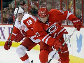 Detroit's Joakim Andersson, left, checks Carolina's Riley Nash Friday in Raleigh, N.C. (AP Photo/Gerry Broome)