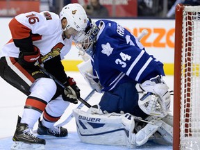 Ottawa's Clarke MacArthur, left, screens Toronto goalie James Reimer Saturday in Toronto. (THE CANADIAN PRESS/Frank Gunn)