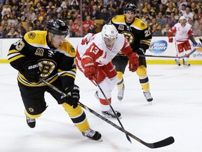 Boston's Brad Marchand, left, is checked by Detroit's Pavel Datsyuk Saturday in Boston. (AP Photo/Robert F. Bukaty)