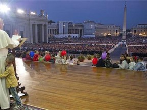 Romano, a young boy, hugs Pope Francis as he delivers his speech during an audience with families in St. Peter's Square gathered for the Pontifical Council for the Family's plenary assembly, at the Vatican on Oct. 26, 2013. (L'Osservatore Romano/Associated Press)