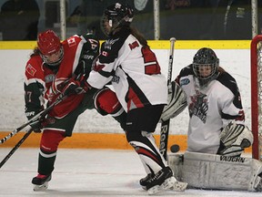 Wildcats goalie Hanna Slater, right, makes a save as teammate Amy Maitre battles London's April Clark during their Provincial Women's Hockey League game Tuesday at Forest Glade Arena. (DAN JANISSE/The Windsor Star)