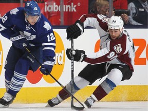 Colorado's Ryan O'Reilly, right, is checked by Mason Raymond of the Maple Leafs during an NHL game at the Air Canada Centre. (Photo by Claus Andersen/Getty Images)