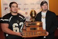 AKO Fratmen lineman John Muresan, left, and  head coach Mike LaChance display the Ontario Football Conference Championship Teddy Morris Memorial Trophy during a news conference in LaSalle, Ontario on October 22, 2013.  JASON KRYK/The Windsor Star)